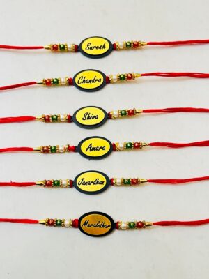 Oval Shaped Acyclic Name Engraved Rakhi